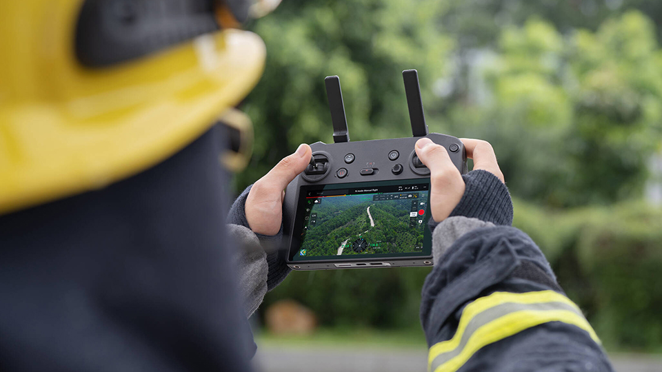 DJI Mavic 3 Thermal portable remote controller being used by firefighter