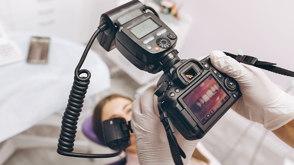 Dentist taking close up photo of patient's smile
