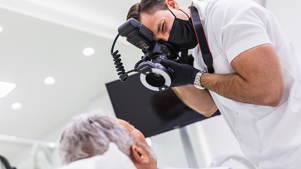 Dentist taking photo of patient's teeth