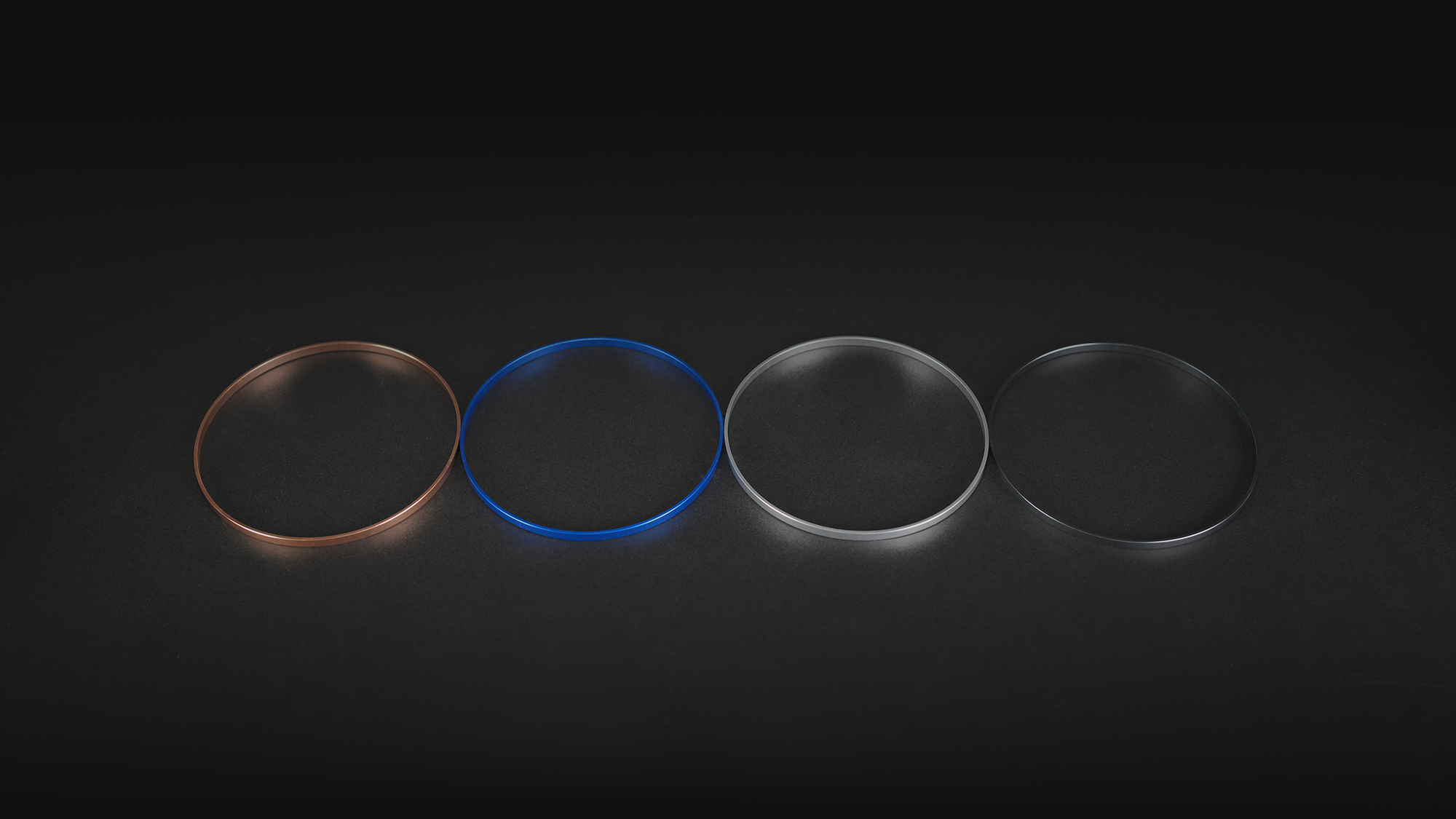 User-Interchangeable Flaring Option Rings in Amber, Blue, Silver, and Clear