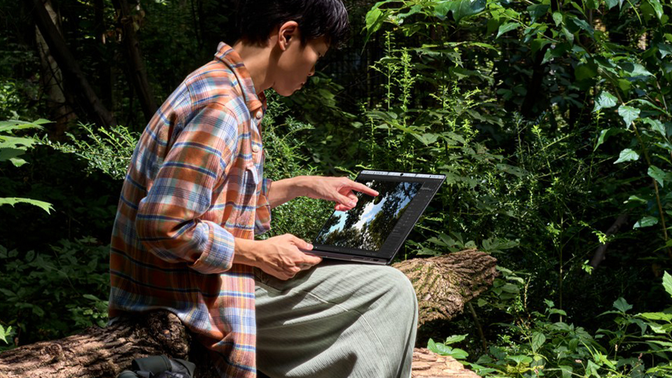 Young man outdoors with Apple 14 Inch MacBook Pro