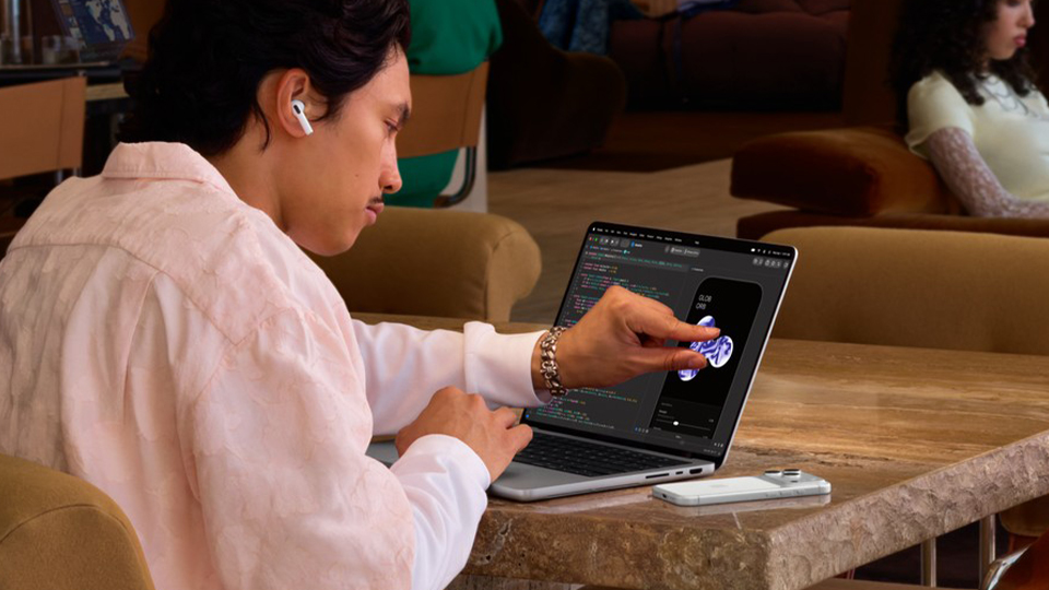 Young man with Apple 14 Inch MacBook Pro