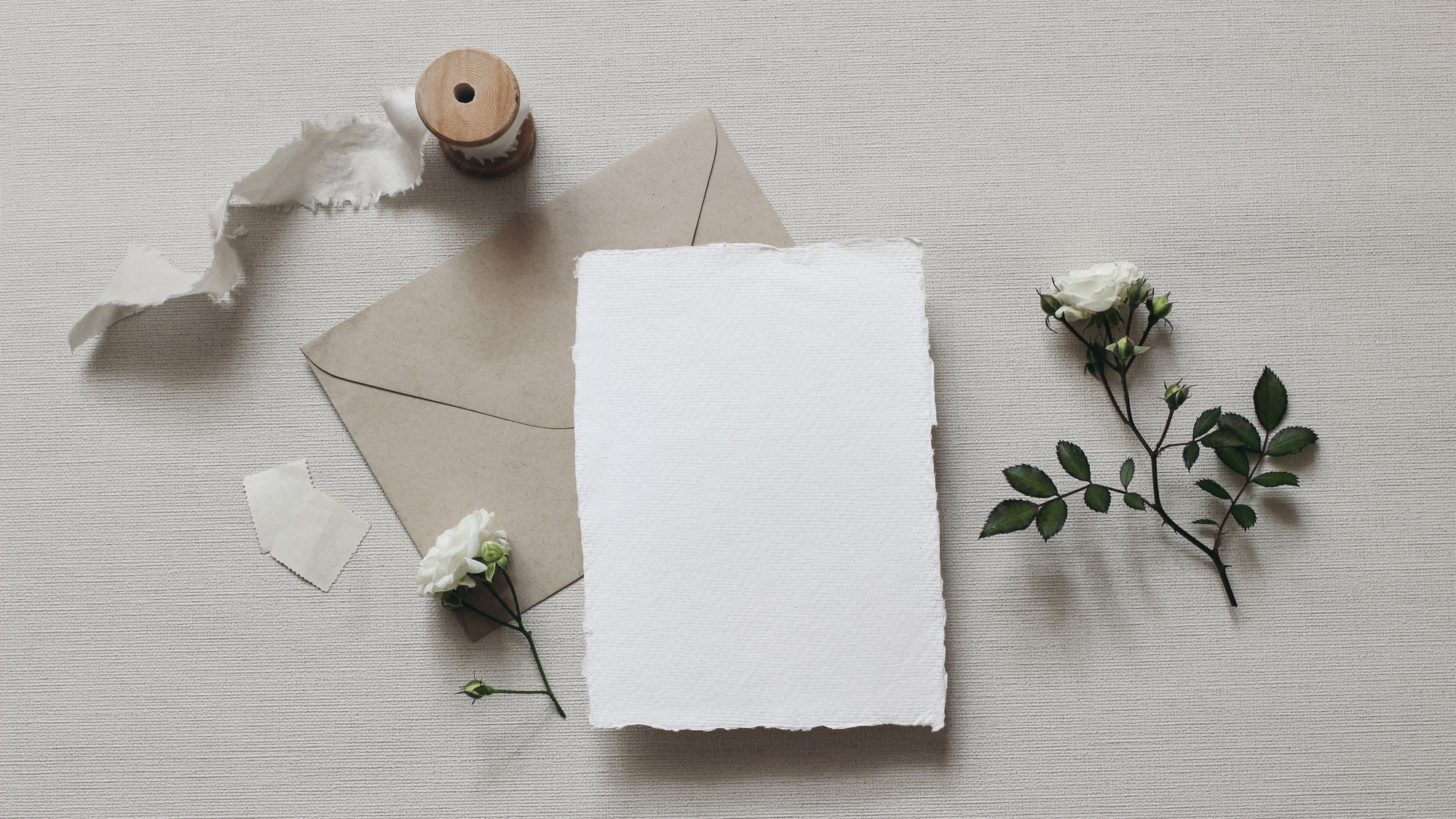Notice how the invitation mock-up is elevated, indicated by the shadow below. This is achieved by using a riser or styling block.